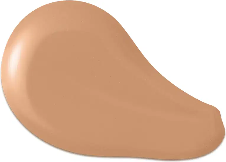 O produto apresentado na imagem é uma base de maquiagem de cor bege escuro, com uma textura cremosa e suave. Sua forma é arredondada e convexa. Não há rótulos, marcas ou outras informações visíveis na imagem.