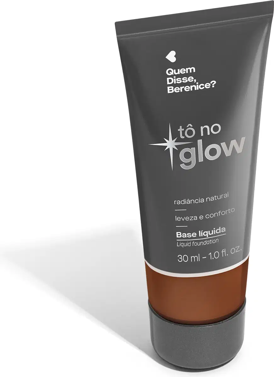 O produto apresentado é uma base líquida da marca Tô no Glow, com embalagem em tubo plástico de cor cinza escura. O rótulo exibe o nome da marca e o texto "Radiância natural, leveza e conforto" em letras brancas.