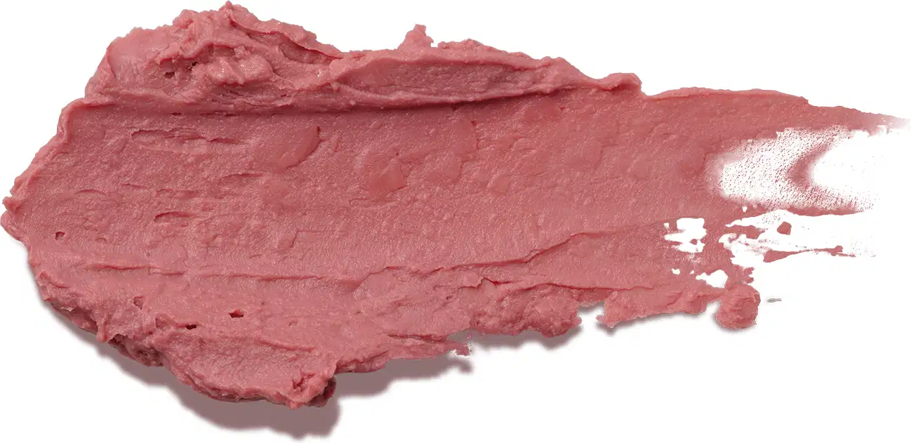 Esta é uma amostra de um balm cremoso de cor rosa escuro. O produto tem uma textura espessa e irregular, formando uma mancha acidentada na superfície. Não há embalagem ou rótulos visíveis na imagem.