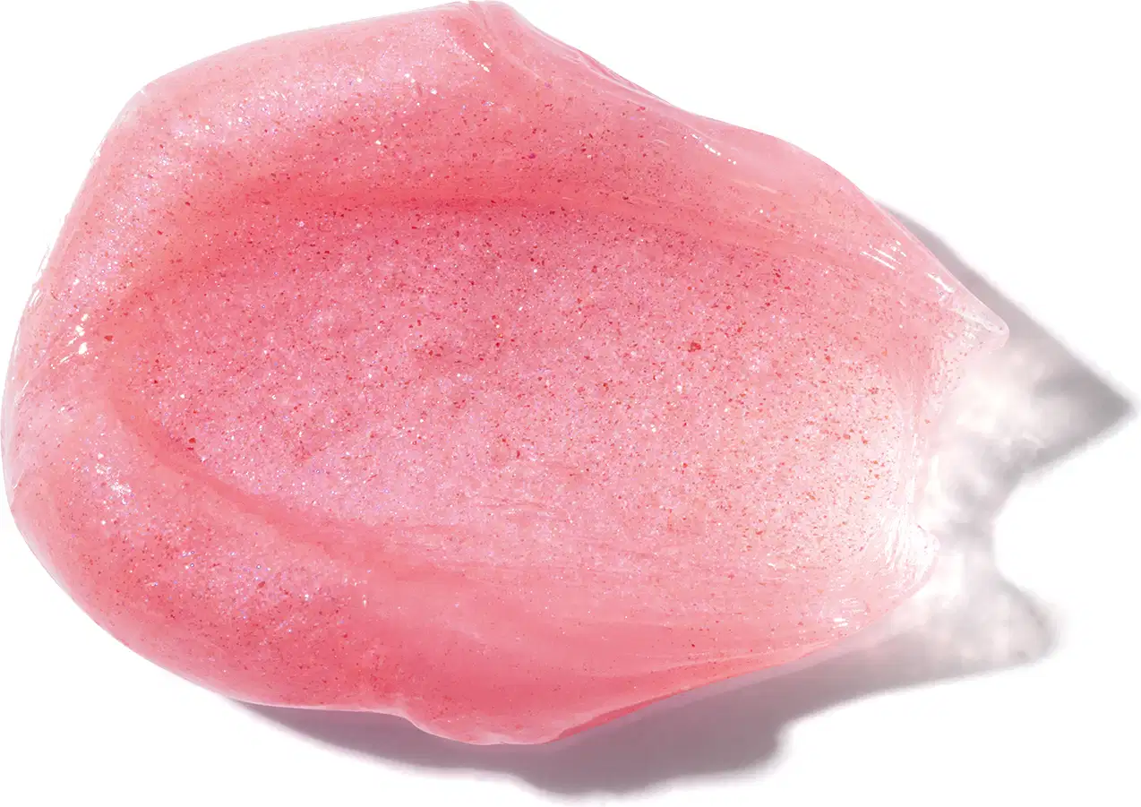 A textura do produto de beleza é semelhante a uma pedra rosa translúcida, com uma superfície brilhante e irregular, sugerindo uma consistência gelatinosa e macia.