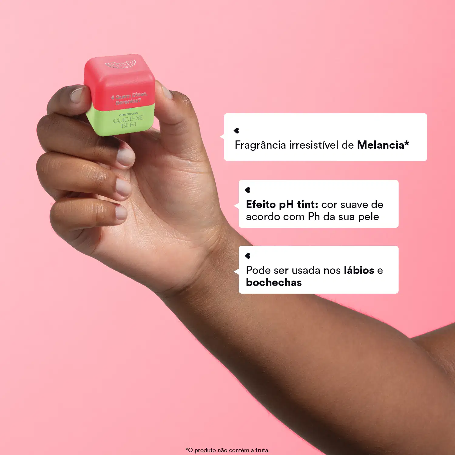 Mão feminina segurando um cubo vermelho e verde de balm labial Melancia Cuide-se Bem Feira Quem Disse, Berenice? em fundo rosa e letras informando as características do produto.