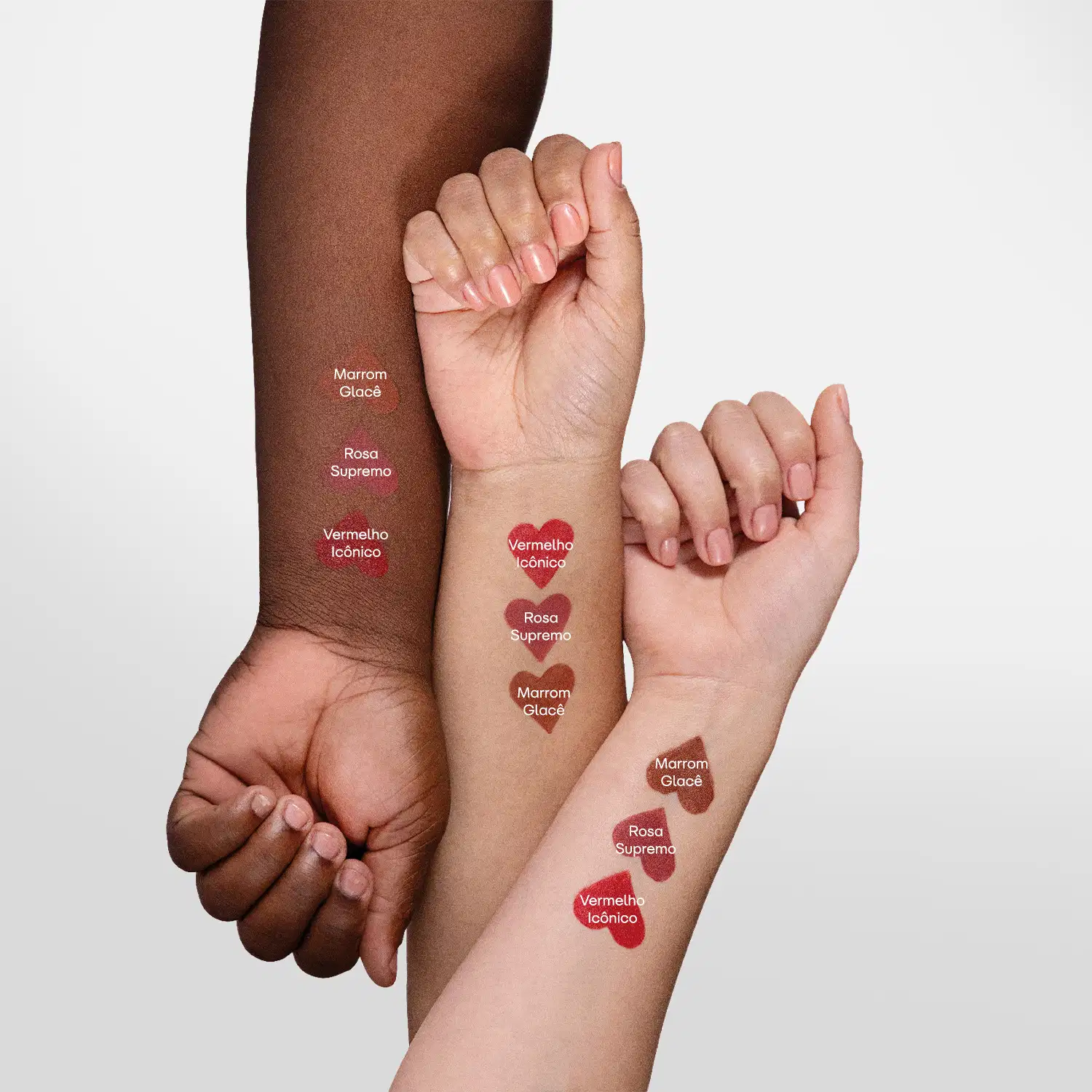 Imagem de três braços femininos com diferentes tonalidades de pele. Em cada um deles, amostras das cores do batom semi matte POP Quem Disse, Berenice?, mostrando como cada uma delas se apresenta.