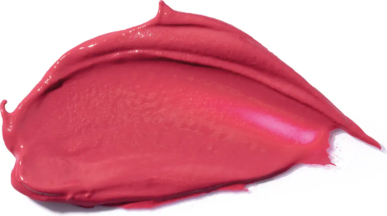 A textura do produto de beleza é uma massa cremosa e brilhante, com uma coloração vermelha intensa e vibrante, sugerindo uma consistência macia e sedosa.