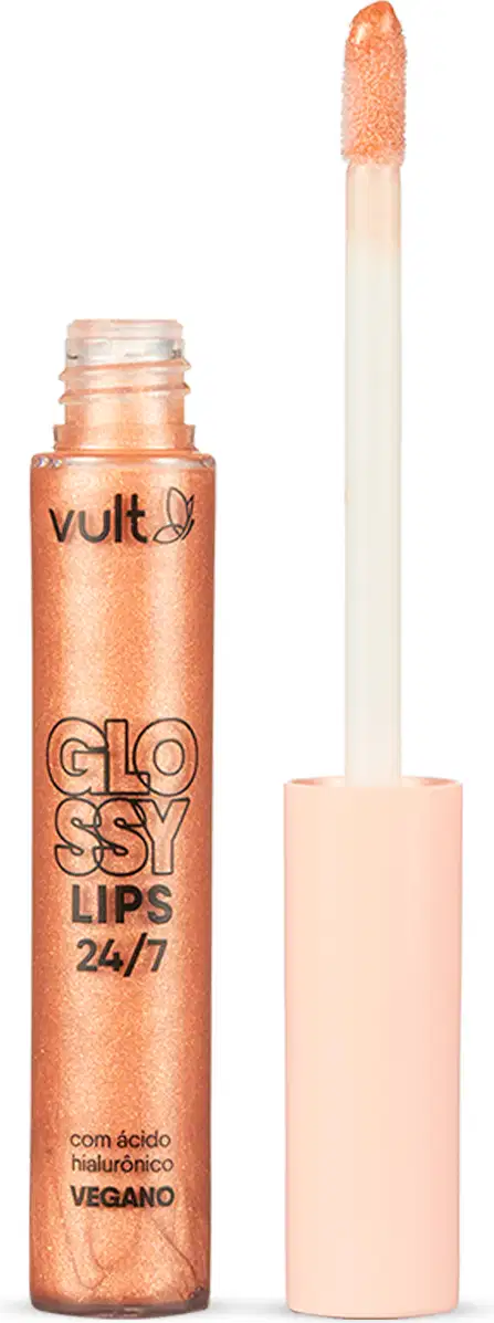 Gloss labial em embalagem cilíndrica transparente contendo o gloss brilhante com tonalidade laranja claríssimo. Produto aberto com tampa salmão claro ao lado da embalagem. Rótulo em letras pretas no centro. Aplicador do tipo pincel firme.