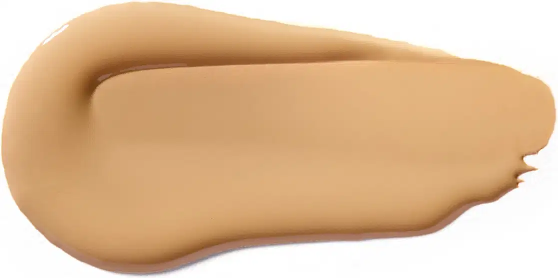 Textura cremosa e suave, com tonalidade bege clara e aspecto uniforme, típica de um produto de base ou corretivo da marca Vult.