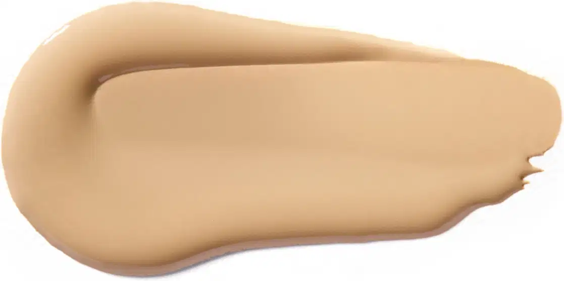Textura cremosa e suave, com tonalidade bege clara e aspecto uniforme, típica de um produto de base ou corretivo da marca Vult.