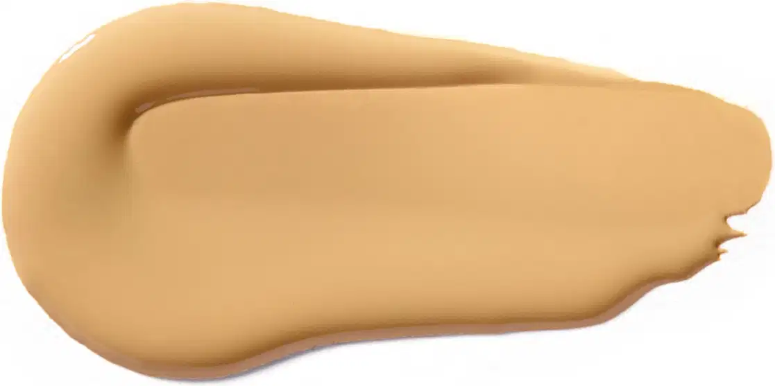 Textura cremosa e suave, com tonalidade bege clara, apresentando aspecto homogêneo e uniforme, típica de um produto de maquiagem da marca Vult.