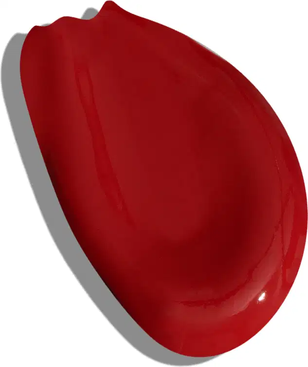 A imagem apresentada é a textura de um batom vermelho da marca Vult, num aspecto líquido e formato irregular. O batom em si não é visível.