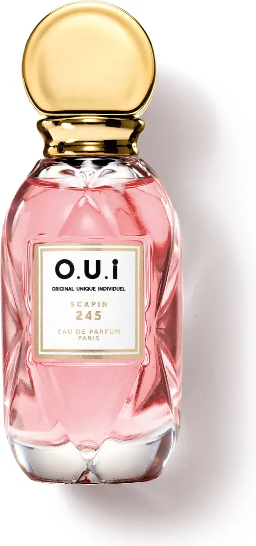 Frasco de perfume O.U.i. Scapin 245, com embalagem de vidro rosa e tampa dourada. Rótulo com o nome da marca e informações sobre o produto.