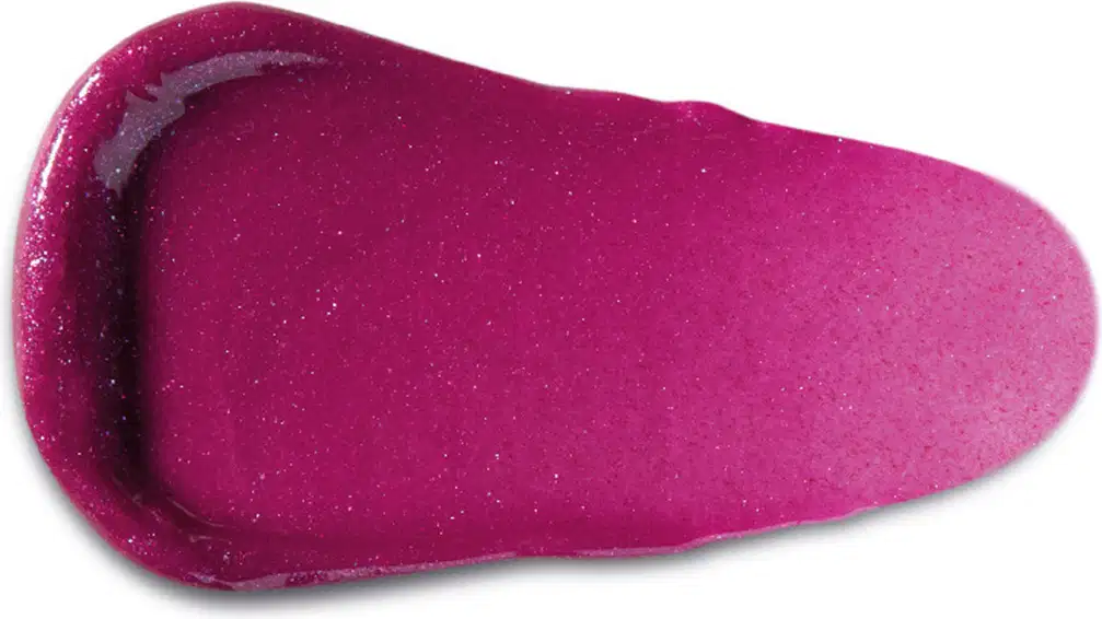 Textura rosa brilhante de item de gloss, com aparência suave e granulada, posicionado sobre superfície clara.
