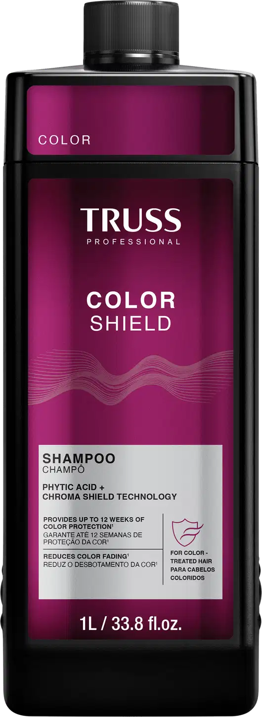 Frasco de item de perfumaria preto e rosa com rótulo "TRUSS PROFESSIONAL COLOR SHIELD". O frasco possui formato cilíndrico com tampa preta. O rótulo apresenta o nome da marca em letras brancas e informações sobre o produto em texto rosa e branco.