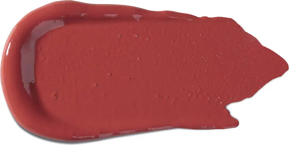 Textura cremosa e brilhante, com tonalidade vermelha intensa e aparência aveludada, típica de um batom da marca Vult.
