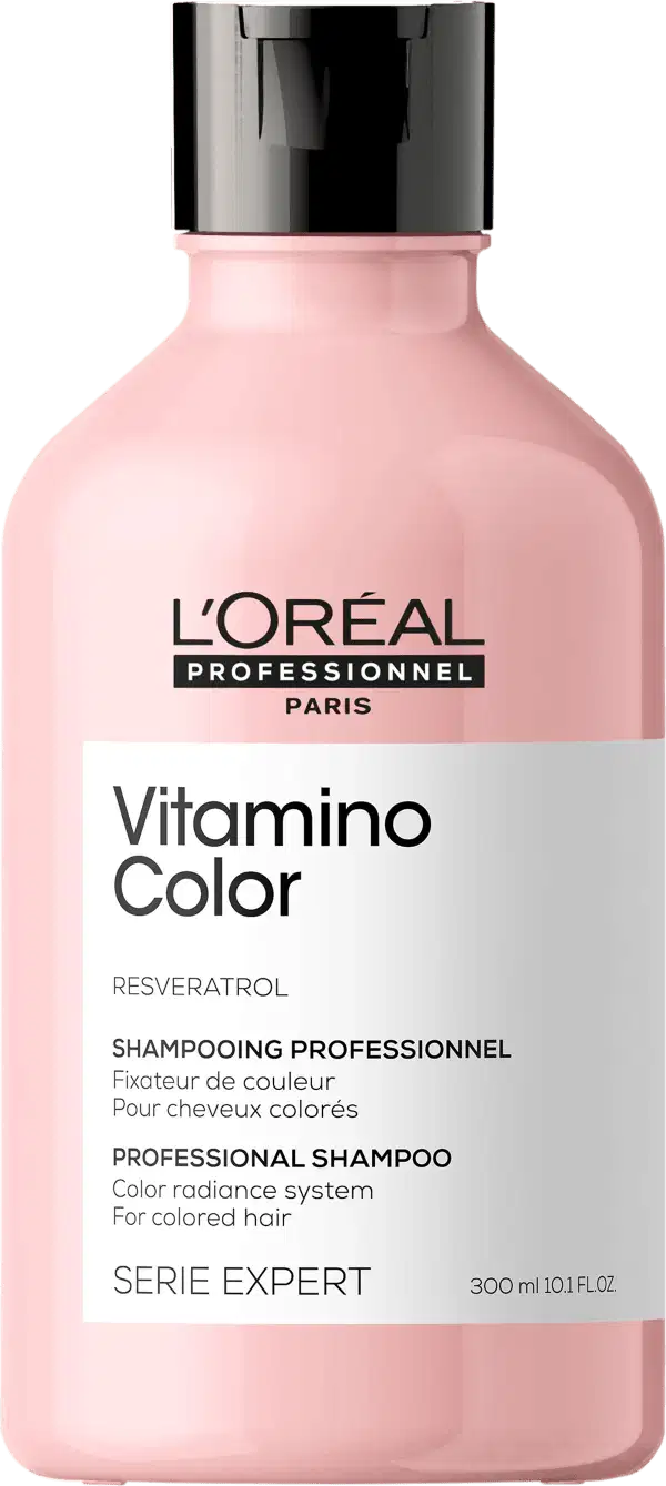 Frasco de plástico rosa com tampa preta. Rótulo com texto "L'OREAL PROFESSIONNEL PARIS Vitamino Color" e "SHAMPOOING PROFESSIONNEL". Produto de cuidados capilares para cabelos coloridos.