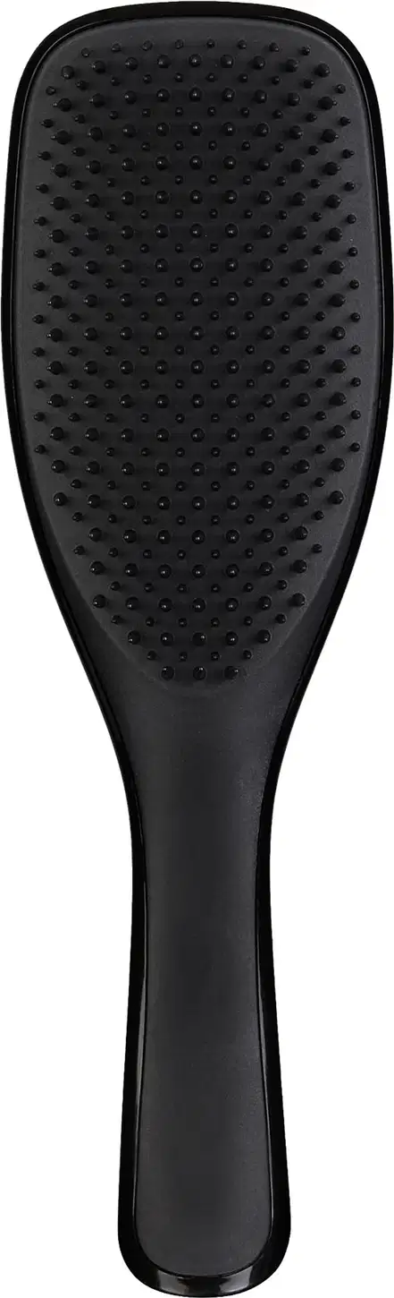 Escova de cabelo preta da marca Tangle Teezer, com design ergonômico e superfície ponteada para facilitar o desembaraço dos fios.