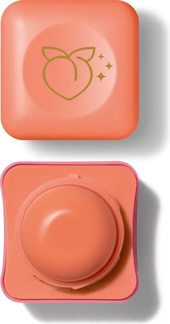 Pote compacto com cantos arredondados nas cores rosa e laranja com roll-on laranja e tampa laranja com ilustração de um pêssego contendo hidratante labial Intense & Cuide-se Bem Leite e Mel.