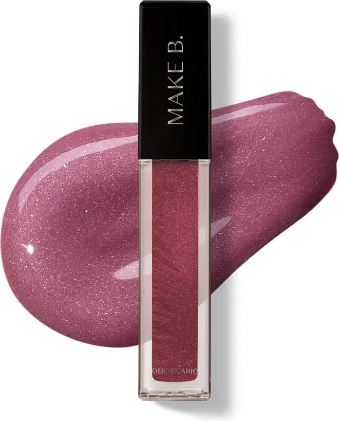 Gloss labial Rose Lover da marca Make B. em frasco retangular transparente com líquido rosa com partículas de glitter e tampa preta com logo da marca, exibido sobre superfície branca com aplicação do produto ao fundo mostrando textura e acabamento.