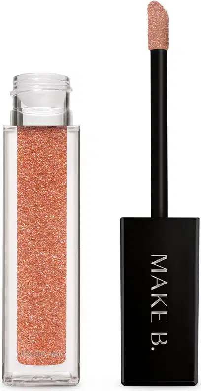 Batom líquido Diamond Dourado Luxury da marca Make B. em tubo retangular transparente, produto de cor dourada, tampa e haste pretas e esponja aplicadora macia.