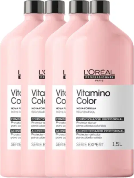 Quatro frascos de condicionador profissional da linha Vitamino Color da L'Oréal Paris, com embalagem rosa clara e rótulos pretos destacando o nome do produto.