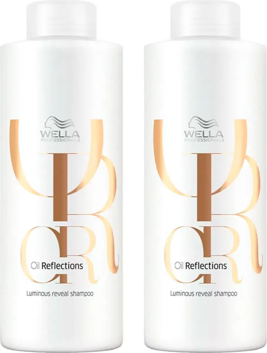 Dois frascos brancos da linha Oil Reflections da Wella Professionals, com rótulos em tons de amarelo e marrom, contendo um shampoo luminoso revelador.