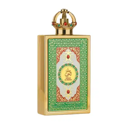 Frasco de perfume dourado com tampa em forma de coroa, decorado com padrões florais verdes e detalhes em vermelho. O rótulo apresenta o nome "Queen of Arabia" em árabe e inglês.