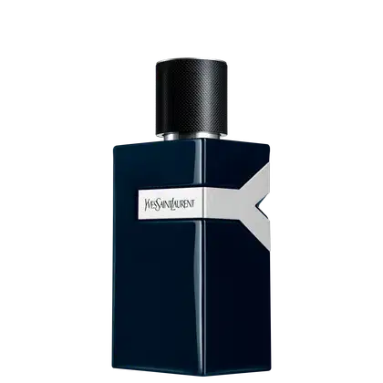 Frasco de perfume Yves Saint Laurent em formato cúbico, com tampa preta de textura aveludada. Embalagem em tons de azul escuro com logotipo da marca em destaque. Produto elegante e sofisticado.