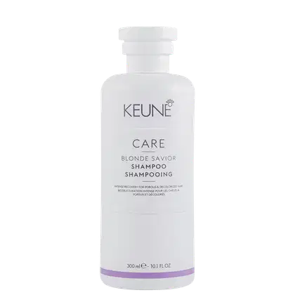 Frasco branco de shampoo da linha Care da Keune, com rótulo em cinza e roxo, indicando ser o "Blonde Savior Shampoo" para cabelos porosos e descoloridos.