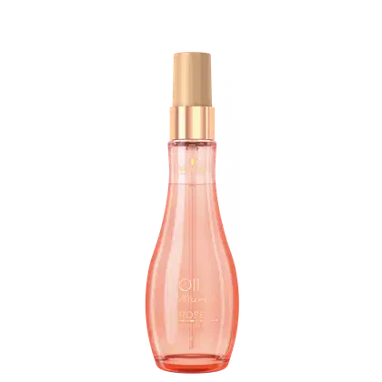 Perfume em frasco de vidro transparente na cor rosa pêssego. A embalagem tem um formato cilíndrico alongado com um bico borrifador na parte superior.