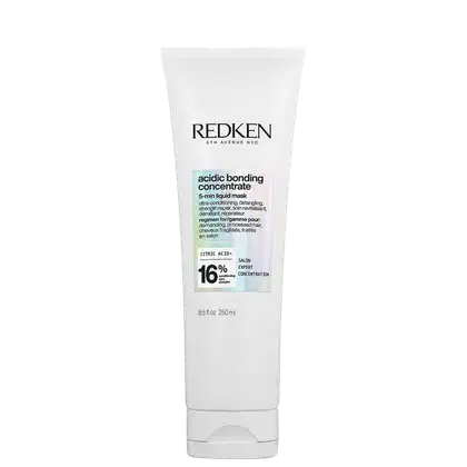 Tubo branco com rótulo preto e azul claro. Texto "Redken 5th Avenue NYC" e "Acidic Bonding Concentrate 5-min Liquid Mask". Informações sobre ingredientes e concentração de ácido cítrico.