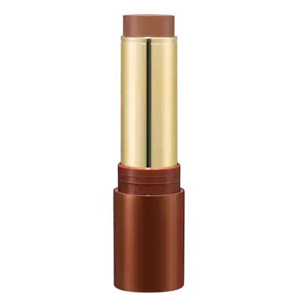 Bronzer em Bastão em embalagem cilíndrica. O estojo é de metal dourado com detalhes em tom de marrom. A parte superior e inferior são de cor cobre fosco. A embalagem tem um design elegante e sofisticado.