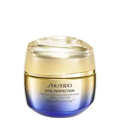 Creme antirrugas e firmador da linha Vital Perfection da Shiseido. Embalagem redonda com tampa dourada. O frasco tem uma coloração azul escura na base que se torna mais clara em direção ao topo.