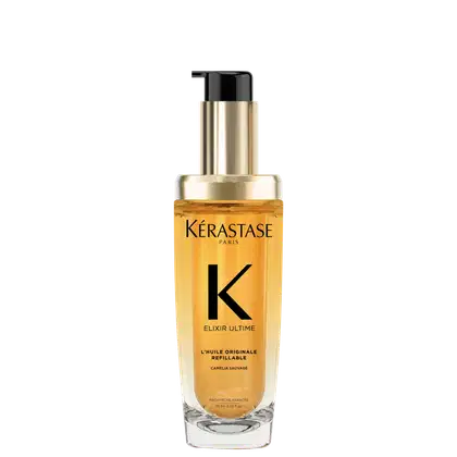 A imagem mostra o óleo capilar da marca Kérastase. O frasco é transparente, permitindo ver o líquido dourado dentro. O frasco tem um formato cilíndrico e uma bomba dosadora preta no topo. O rótulo apresenta letras pretas sobre um fundo dourado.