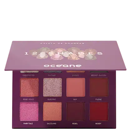 A imagem mostra paleta de sombras Océane com 12 cores. Embalagem retangular em tons de roxo. Na tampa, o nome "12 Shades" e logotipo da marca. Internamente, sombras em pó com acabamentos cintilantes e foscos em rosa, dourado, marrom, bege e vermelho.