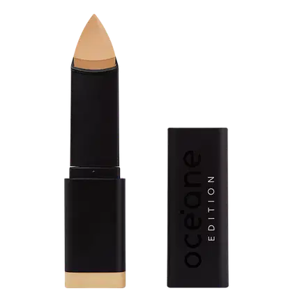 A imagem mostra a Base em Bastão Océane Edition Foundation Stick: embalagem preta com o logotipo "Océane Edition" impresso em relevo na parte frontal. A base tem formato triangular.