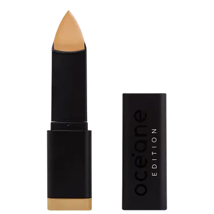 A imagem mostra a Base em Bastão Océane Edition Foundation Stick aberta e com a tampa do lado. Possui embalagem preta fosca com o logotipo "Océane Edition" impresso em letras brancas e pretas. A ponta da base tem formato triangular.