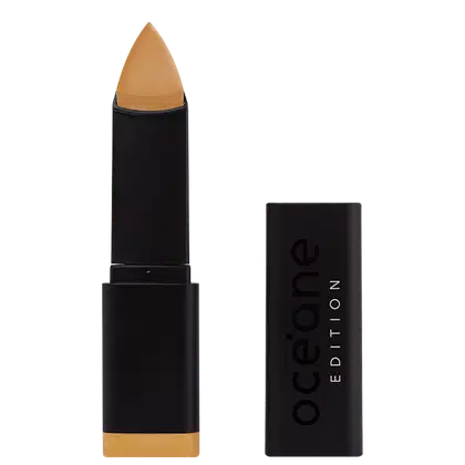 A imagem mostra a Base em Bastão Océane Edition Foundation Stick: embalagem retangular preta com o logotipo "Océane Edition" impresso em relevo na parte frontal. A base tem formato triangular.