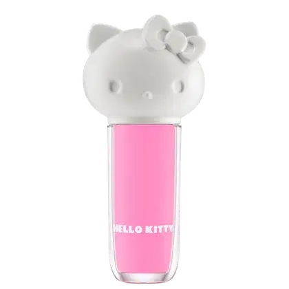Maquiagem em formato cilíndrico com a cabeça da personagem Hello Kitty como tampa. A parte superior é branca com detalhes em relevo que representam os olhos, orelhas e laço da Hello Kitty. É possível ver a cor do produto pelo corpo transparente.