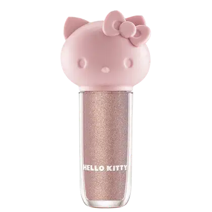 Maquiagem em formato cilíndrico com a cabeça da personagem Hello Kitty como tampa. A parte superior é rosa com detalhes em relevo que representam os olhos, orelhas e laço da Hello Kitty. É possível ver a cor do produto pelo corpo transparente.
