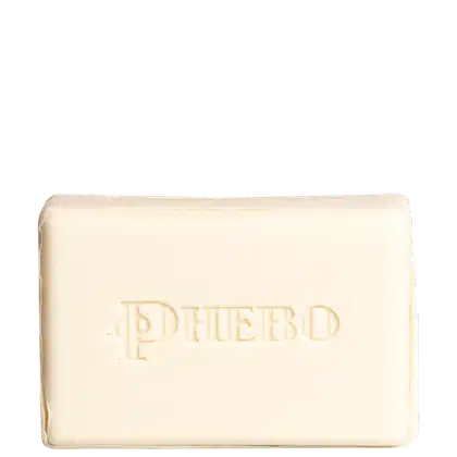 Barra de sabonete retangular em cor bege claro. Possui o nome "Phebo" gravado em relevo na superfície superior com letras em baixo relevo na mesma cor bege.