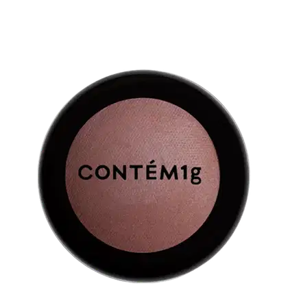 A imagem mostra uma embalagem fechada de blush. A embalagem é preta com parte transparente e o logo da marca em preto.