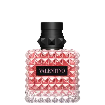 Frasco de perfume Valentino em formato geométrico, com tampa preta e corpo de vidro rosa brilhante, exibindo o nome da marca em destaque.