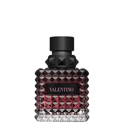 Frasco de perfume Valentino com design facetado em tons de rosa e preto, com rótulo destacado em letras pretas.