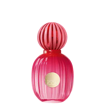 Frasco de perfume com formato esférico e listras verticais em tons de rosa, com rótulo dourado com a marca "Banderas Icon" no centro.