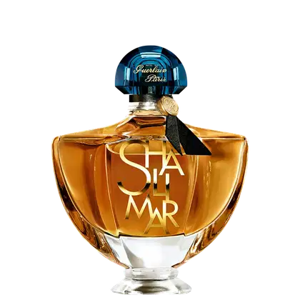 Frasco de perfume Guerlain Paris com tampa de cristal azul e rótulo dourado com a inscrição "Shalimar". Embalagem de vidro âmbar com design elegante e clássico.
