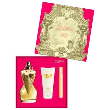 Conjunto de produtos de beleza da marca Jean Paul Gaultier, incluindo um frasco de perfume dourado com detalhes em relevo, um tubo de creme e um frasco menor, todos embalados em uma caixa rosa com elementos decorativos dourados.