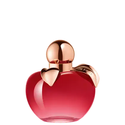 Frasco de perfume em formato de coração, com tampa dourada, em cor vermelha brilhante. Rótulo com texto "Nina Ricci" visível na embalagem.