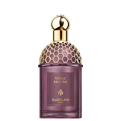 Frasco de perfume Guerlain Tabac Sahara, com design elegante e geométrico em tons de roxo e dourado, destacando o nome da fragrância e a marca.
