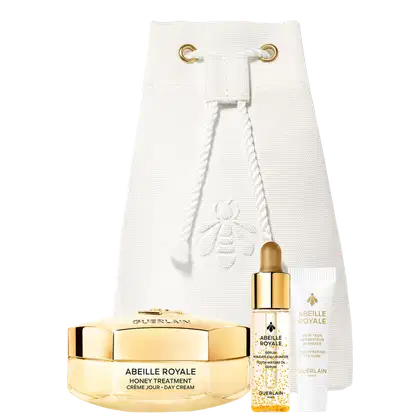 Bolsa branca com detalhes dourados contendo item de perfumaria da marca Guerlain. Inclui frasco com conta-gotas, creme em pote dourado e tubo de cuidados para os olhos. 