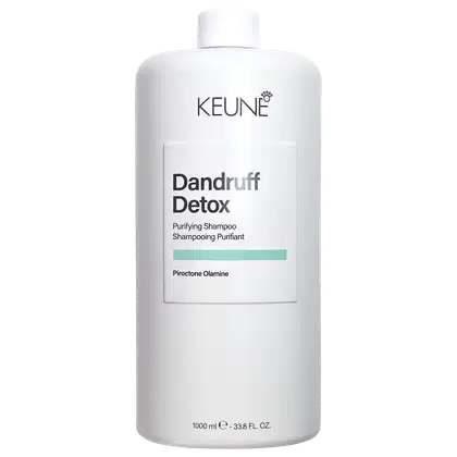 Frasco branco da marca Keune contendo 1000 ml de Shampoo Purificante Dandruff Detox, com informações sobre o produto em texto preto e cinza.