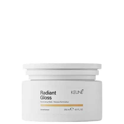 Frasco branco com rótulo da marca Keune, contendo "Radiant Gloss", uma máscara iluminadora de 250 ml. O produto apresenta uma faixa dourada no rótulo, indicando sua função de realçar o brilho e a luminosidade dos cabelos.