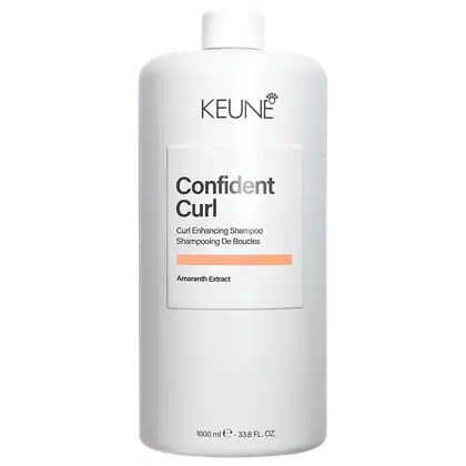 Frasco branco da linha Confident Curl da Keune, contendo 1000 ml de shampoo para realçar cachos. Rótulo com o nome da marca e do produto em destaque.